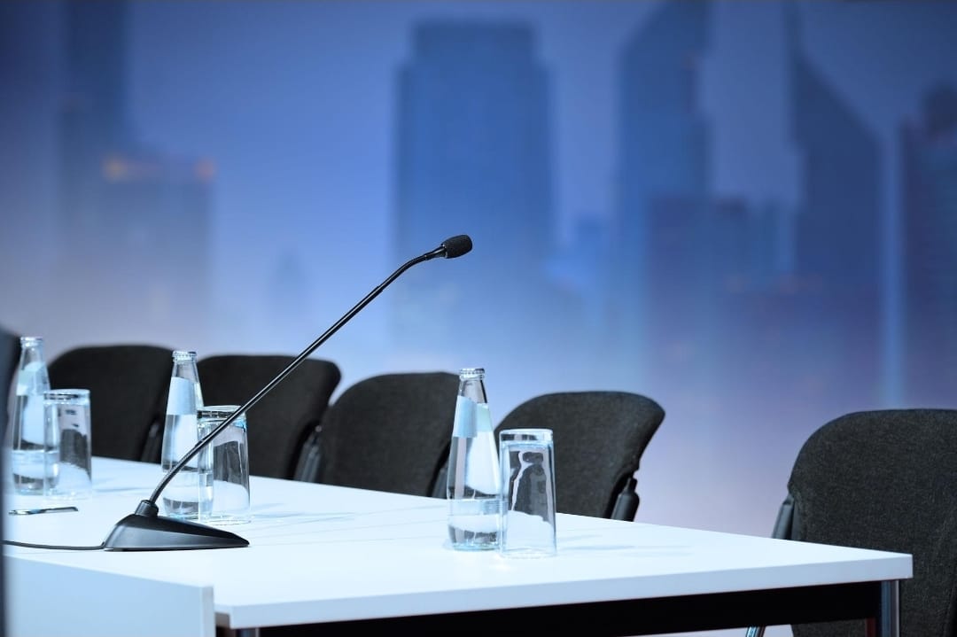 Conference microphone on a desk in a professional setting