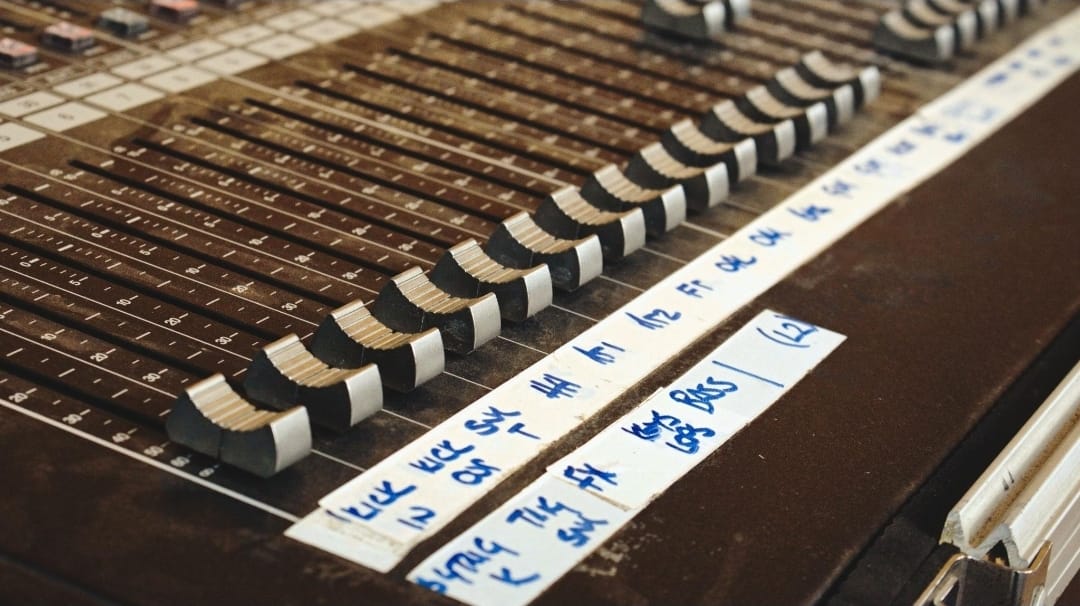 Close-up of mixing desk faders during a live event