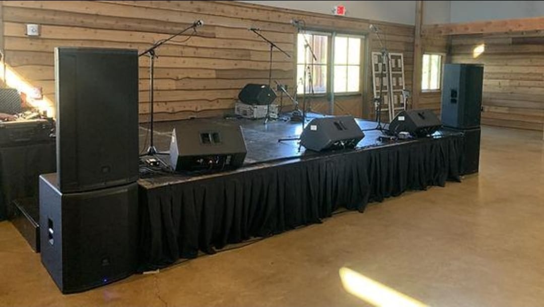 Full stage setup with speakers and monitors at a venue