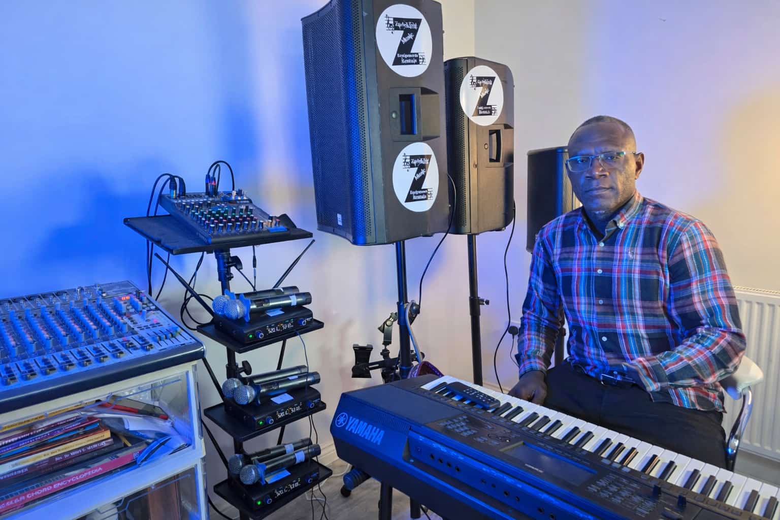 Full studio setup with speakers, keyboard, and mixer rack